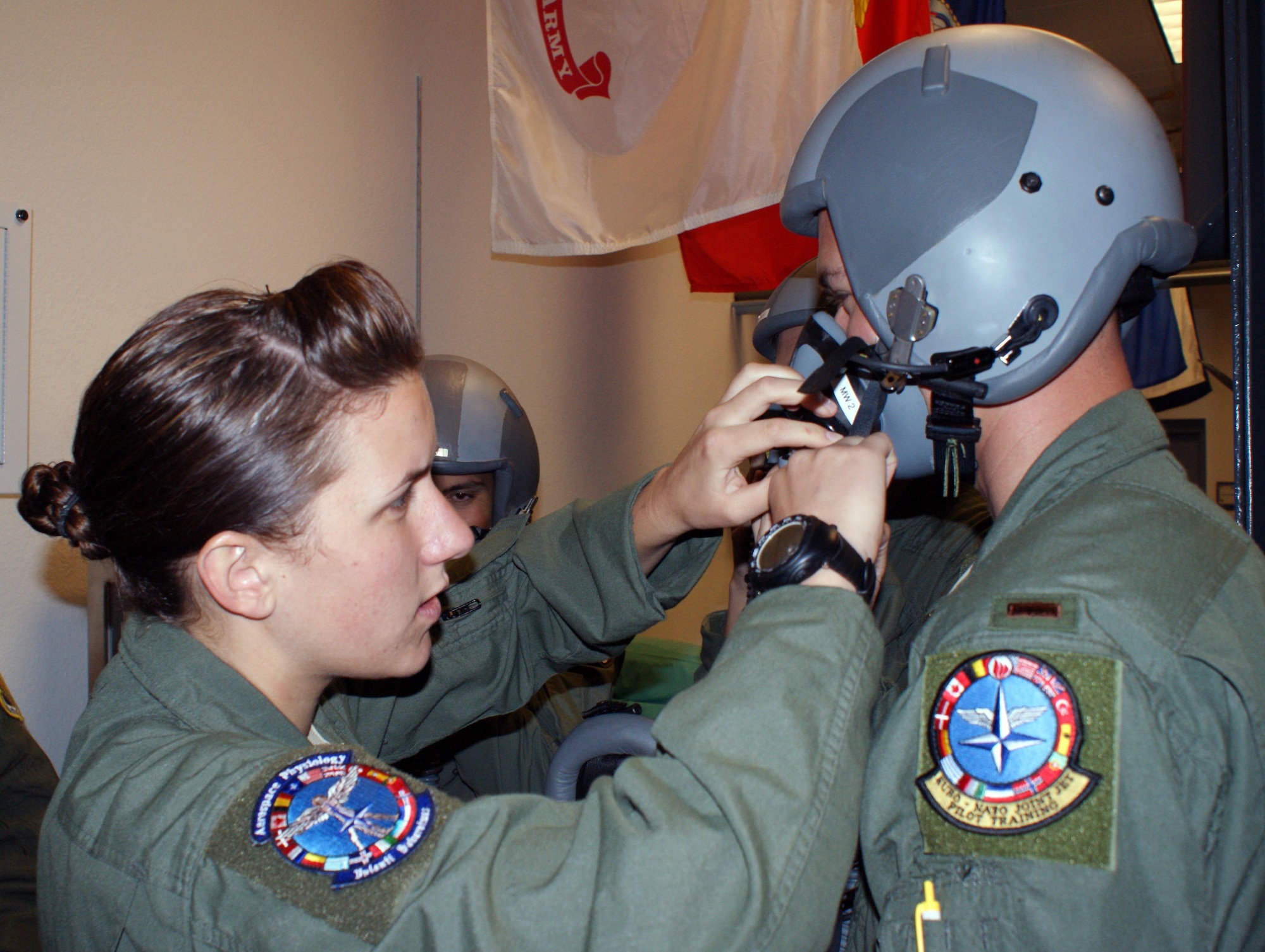 Airman 1st Class Allison Freeman, 82nd Aerospace Medicine Squadron aerospace and operational physiology technician, assists a Euro-NATO Joint Jet Pilot Training student with his oxygen mask prior to an altitude chamber flight Jun 8, 2012 at Sheppard Air Force Base, Texas.  Undergraduate Pilot Training students are exposed to low-pressure altitude flights to experience the onset of hypoxia, or a lack of oxygen to the blood and brain, as part of the physiology training required of all military aviators. (U.S. Air Force photo/Dan Hawkins)