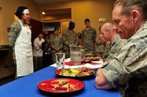 MINOT AIR FORCE BASE, N.D. --  Col. James Dawkins, 5th Bomb Wing commander, examines the 91st Missile Wing’s efforts during the “Warrior Chef 2012” competition, here June 27. The annual competition gave Team Minot chefs the chance to demonstrate their skills and be recognized for their talents in a friendly environment. It was a true test of culinary mastery as a team from each wing went head-to-head in a 45-minute, ultimate dish showdown. (U.S. Air Force photo/Senior Airman Desiree W. Esposito)