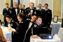 Members of the 3d Weather Squadron Detachment 2 sing karaoke during the 75th Anniversary Dining-Out at the Killeen Civic Center, Killeen, Texas June 25, 2012. The group sang songs to build unit morale. (U.S. Air Force photo by Staff Sgt. Joshua J. Garcia/Released)
