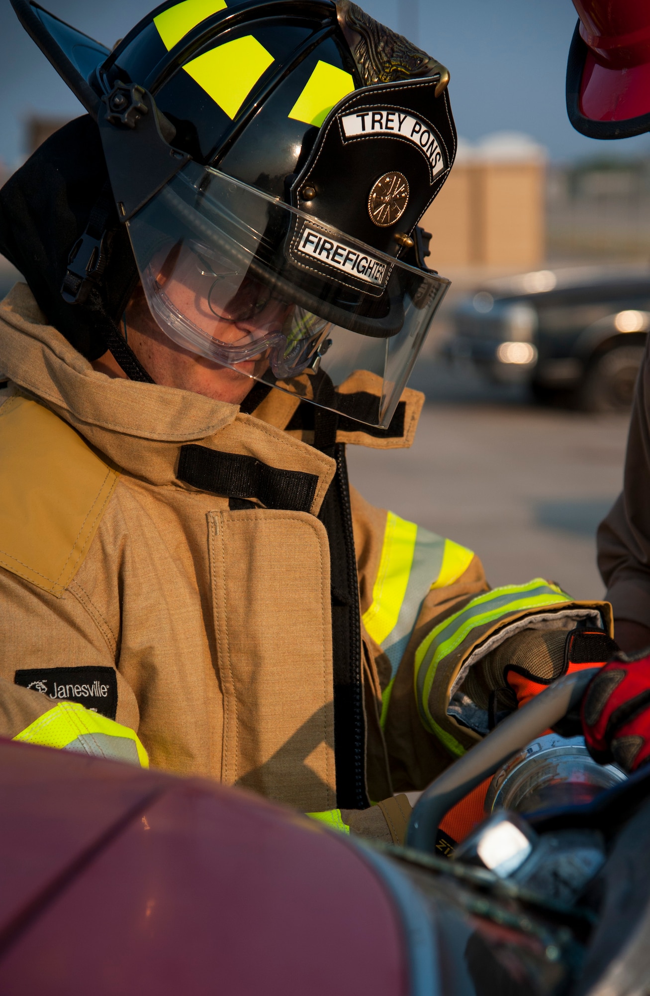 GOODFELLOW AIR FORCE BASE, Texas-- Maxwell “Trey” Pons III, Honorary Air Force firefighter, uses the Jaws of Life to cut the roof off of a car at the Louis F. Garland DOD Fire Academy June 28. Pons suffers from autism and has had a lifelong dream to become an Air Force firefighter. (U.S. Air Force photo/Airman 1st Class Michael Smith)