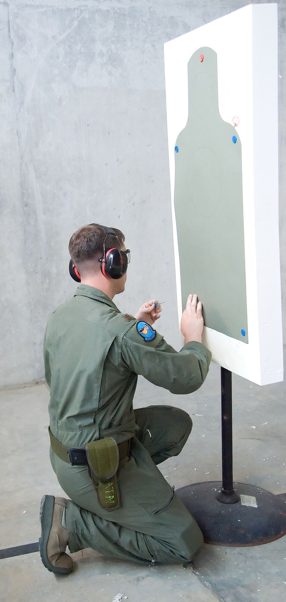Maj. Dave Boytim hangs a shooting silhouette June 28, 2012, during a Combat Arms Training and Maintenance class at Dover Air Force Base, Del. Silhouettes are used to determine shooting accuracy of the member. (U.S. Air Force photo by Adrian R. Rowan)