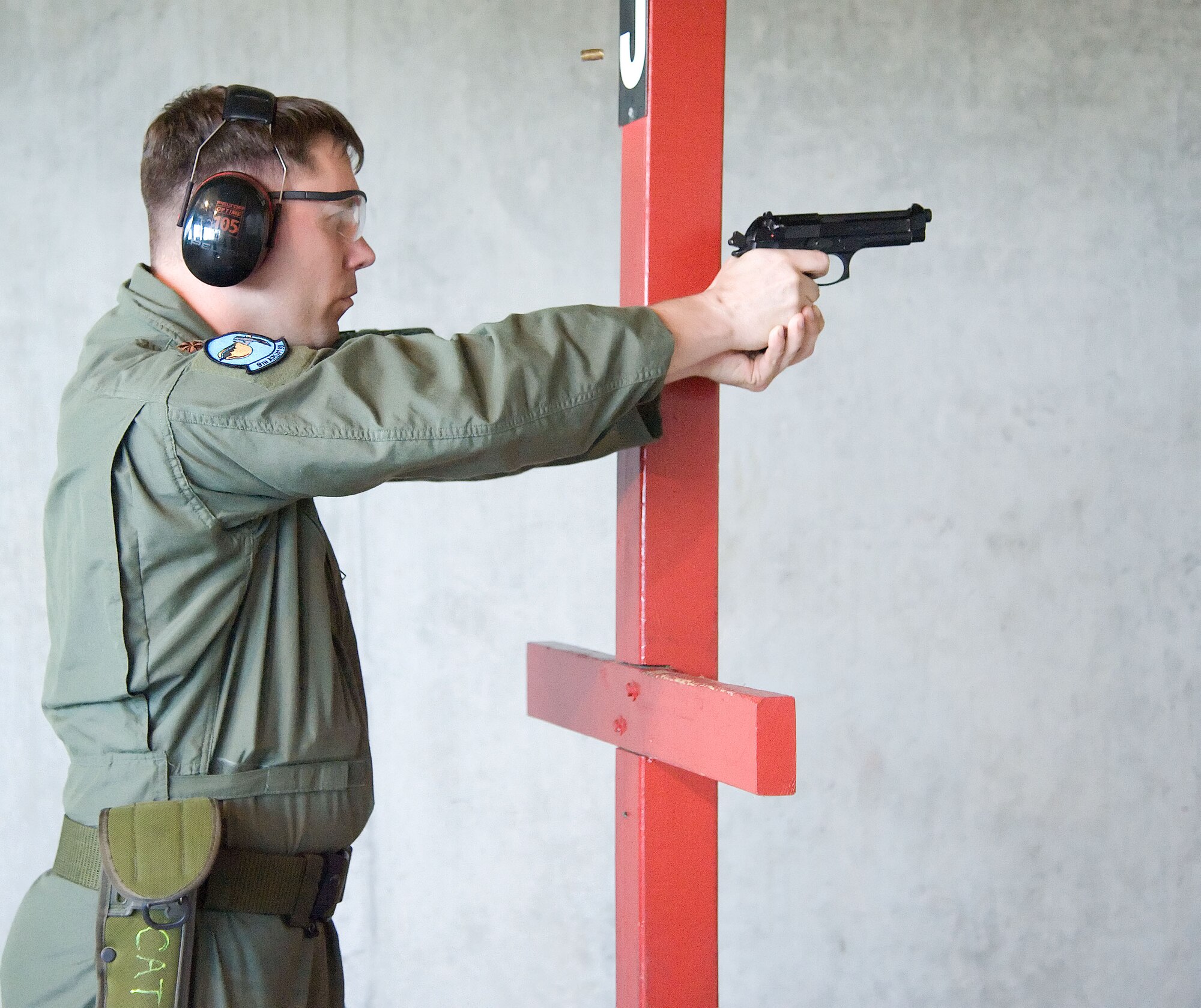 Maj. Dave Boytim shoots an M-9 June 28, 2012, during a Combat Arms Training and Maintenance class at Dover Air Force Base, Del. Team Dover members must qualify on weapons in order to deploy. (U.S. Air Force photo by Adrian R. Rowan)