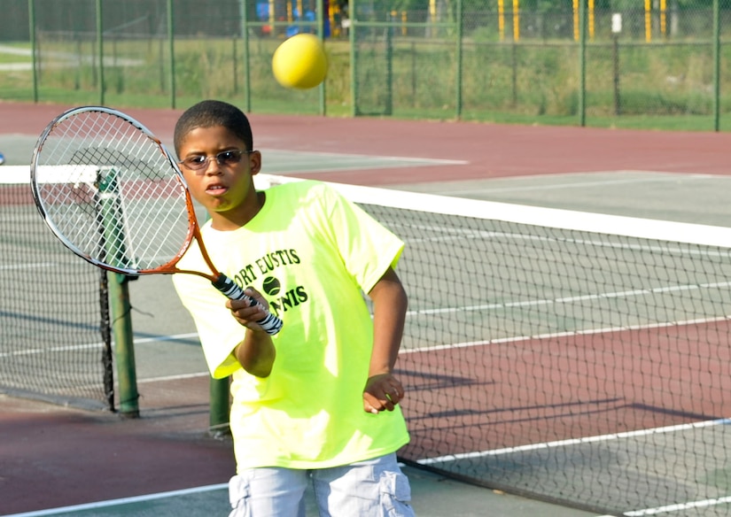 Ten year-old Brandon Miller practices returning the ball during tennis practice as part of the new program being offered by the Child Youth and School Services office, June 28, 2012 at Fort Eustis, Va. The drill is one of many that participants perform to teach racket control as part of the new tennis program.  (U.S. Air Force photo by Senior Airman Wesley Farnsworth/Released)