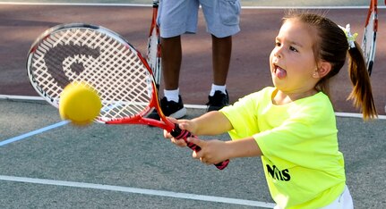 Four year-old Elsie Dabney swings at a tennis ball during a drill as part of the new tennis program being offered by the Child Youth and School Services office, June 28, 2012 at Fort Eustis, Va. The new program will be offered twice a year to children ages 10 and under. (U.S. Air Force photo by Senior Airman Wesley Farnsworth/Released)