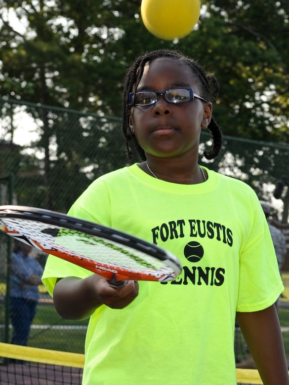 Nine year-old Tomiko Hope practices bouncing a tennis ball on her racket at the Fort Eustis, Va. tennis courts, June 28, 2012.The drill of bouncing the ball is one of many that participants perform to teach racket control, as part of the new tennis program offered by the Child Youth and School Services office. (U.S. Air Force photo by Senior Airman Wesley Farnsworth/Released)