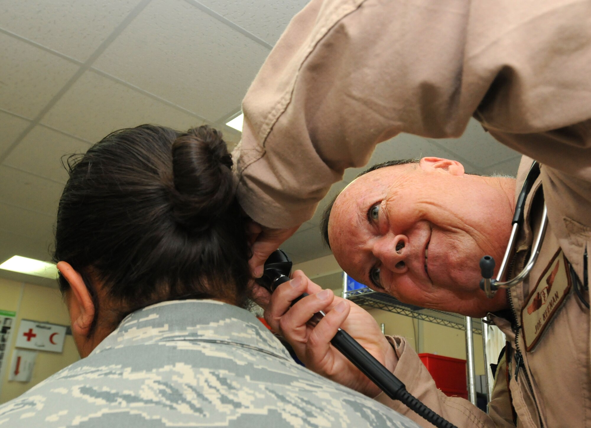 SOUTHWEST ASIA - U.S. Air Force Lt. Col. (Dr.) Joseph Keenan, 380th Expeditionary Medical Group flight doctor, checks a patient's ears June 26, 2012. Keenan joined the Massachusetts Air National Guard at the age of 61. (U.S. Air Force photo/Tech. Sgt. Amanda Savannah)