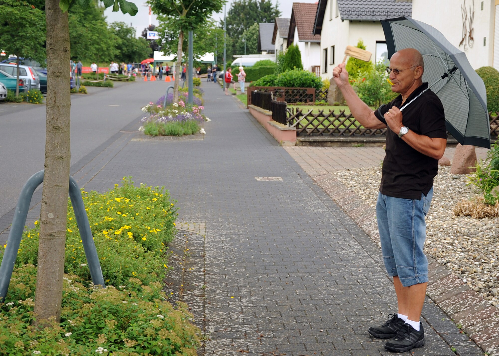 SPANGDAHLEM AIR BASE, Germany – Dieter Mende, a resident of Binsfeld, blows a whistle and spins a clacker during the ninth annual German-American Friendship Run in Binsfeld July 1. Some of the town’s residents lined the streets to cheer on and encourage the runners during the races. More than 300 Germans and Americans participated in the run, which focuses on building partnerships and relationships between the two countries’ peoples. (U.S. Air Force photo by Staff Sgt. Daryl Knee/Released)