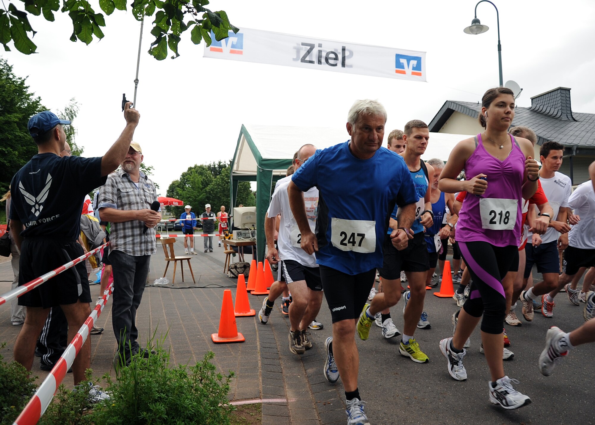 SPANGDAHLEM AIR BASE, Germany – Col. David Julazadeh, 52nd Fighter Wing vice commander, left, fires the starting signal for the five kilometer race of the ninth annual German-American Friendship Run in Binsfeld July 1. More than 300 Germans and Americans participated in the run, which focuses on building partnerships and relationships between the two countries’ peoples. (U.S. Air Force photo by Staff Sgt. Daryl Knee/Released)