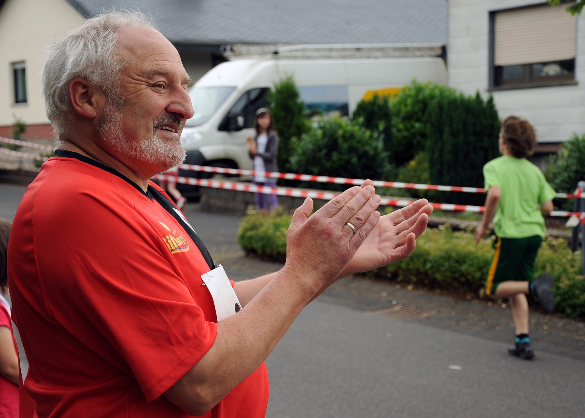 SPANGDAHLEM AIR BASE, Germany – Arnold Weber, German-American Friendship Run participant, claps as a child from the 13-16 year old age group approaches the finish line of a 1,700 meter race in Binsfeld July 1. The race organizers separated the runs into six categories to balance ability levels. More than 300 Germans and Americans participated in the ninth annual run, which focuses on building partnerships and relationships between the two countries’ peoples. (U.S. Air Force photo by Staff Sgt. Daryl Knee/Released)