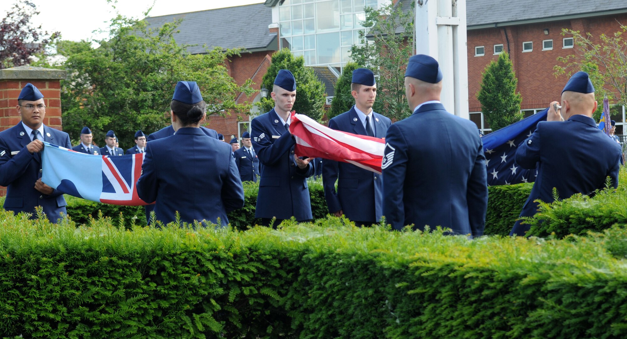 RAF MILDENHALL, England – Team Mildenhall Airmen prepare to fold the U.S. and U.K. flags during the monthly retreat ceremony at the flag pole June 29, 2012. The ceremony pays homage to the flags as well as signifying the end of the duty day. (U.S. Air Force photo/Senior Airman Rachel Waller)