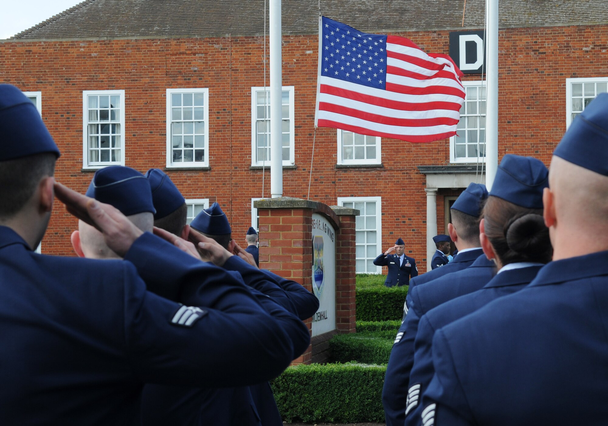 RAF MILDENHALL, England – Team Mildenhall Airmen salute during the playing of U.K. and U.S. national anthems during a retreat ceremony June 29, 2012, here. Retreat signals the end of the duty day.  (U.S. Air Force photo/Senior Airman Rachel Waller)
