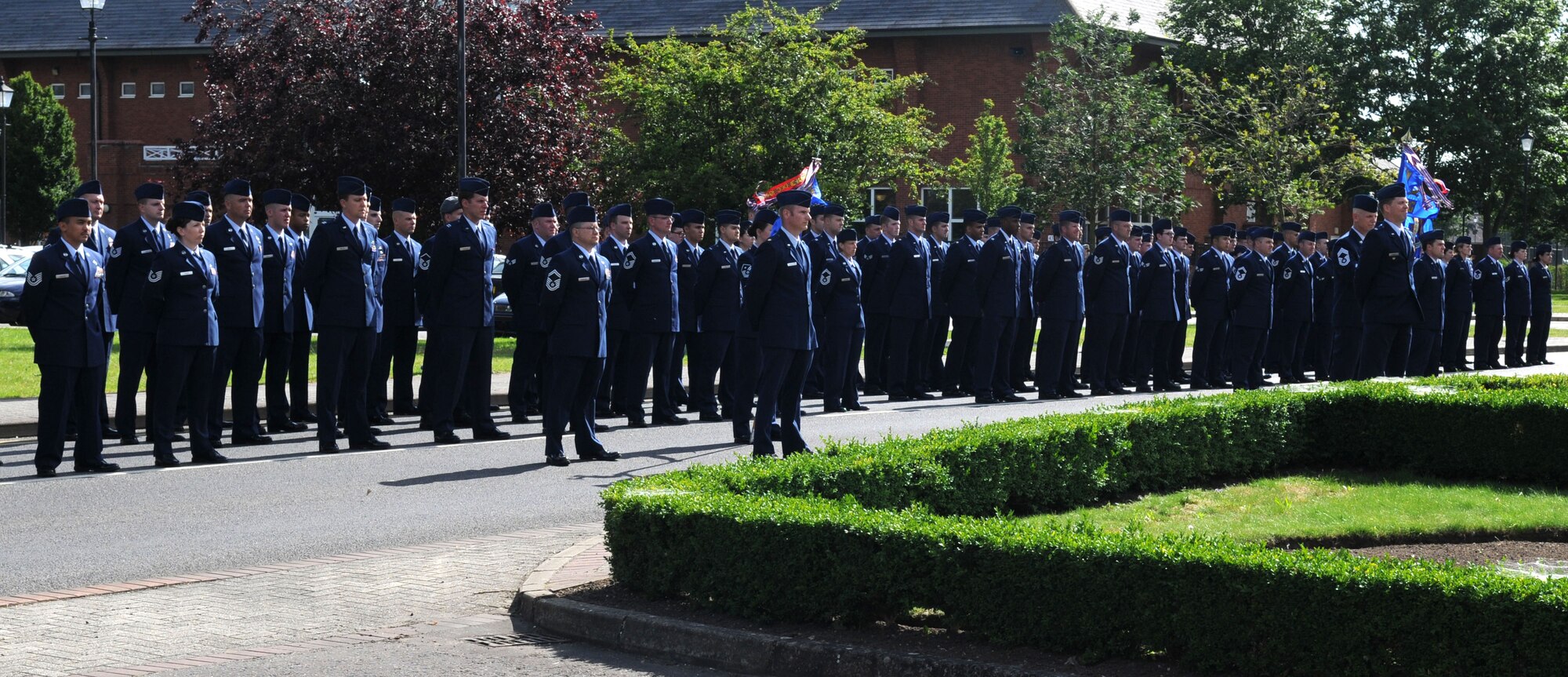RAF MILDENHALL, England – Airmen from the 100th Air Refueling Wing staff agencies, 100th Operations Support Squadron, 351st Air Refueling Squadron and 727th Air Mobility Squadron stand at parade rest while waiting for retreat to sound in front of the 100th ARW headquarters building June 29, 2012. A retreat ceremony is held the last Friday of every month to honor and retire both the U.S. and Royal Air Force flags. (U.S. Air Force photo/Senior Airman Rachel Waller)
