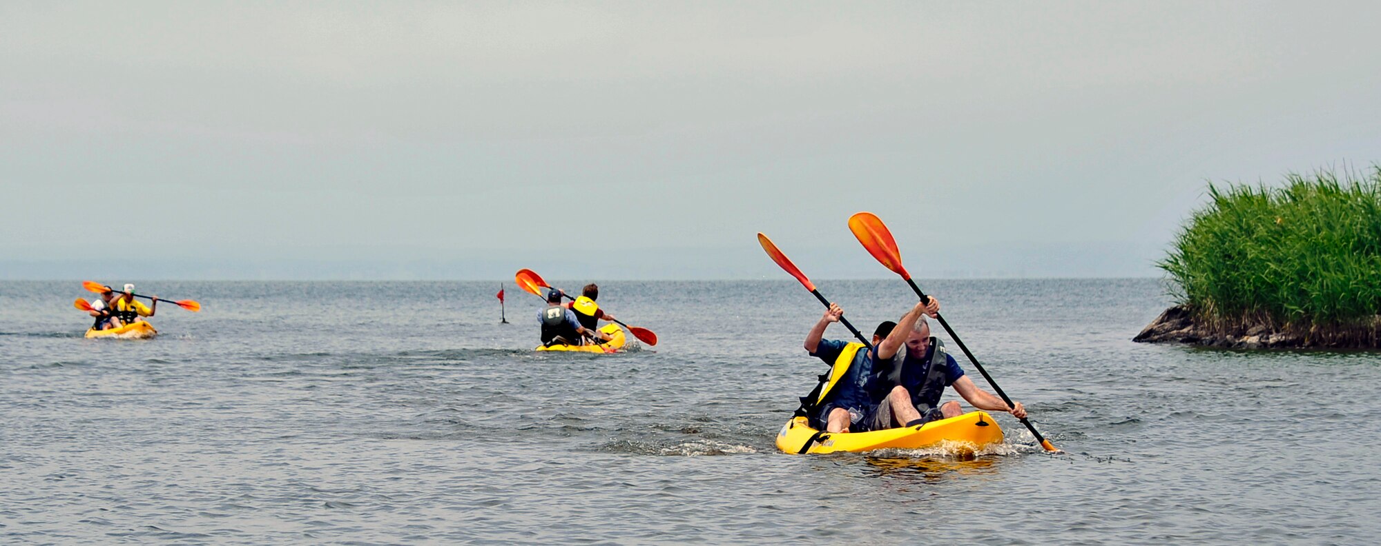 Participants in the Sports Day event compete in the kayak relay race at Misawa Air Base, Japan, June 30, 2012. Despite differences in culture, the Japanese and U.S. participants discovered they had a great deal in common as they competed together in various events.  (U.S. Air Force photo by Staff Sgt. Nathan Lipscomb/Released)