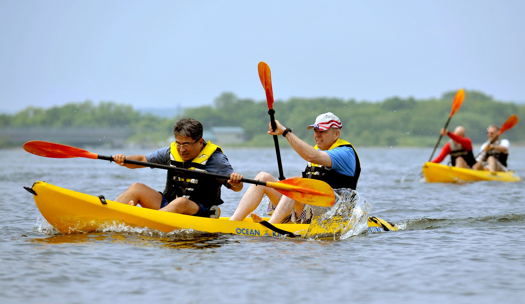 Japan Air Self Defense Force Col. Hitohiko Iwasaki, left, 3rd Air Wing vice commander and Col. Al Wimmer, right, 35th Fighter Wing vice commander, compete in a kayak relay race during Sports Day at Misawa Air Base, Japan, June 30, 2012. Distinguished members of the Misawa City community, United States Air Force and Japan Air Self Defense Force gathered at the base beach to get to know one another and strengthen bilateral relations through friendly competition. (U.S. Air Force photo by Staff Sgt. Nathan Lipscomb/Released)