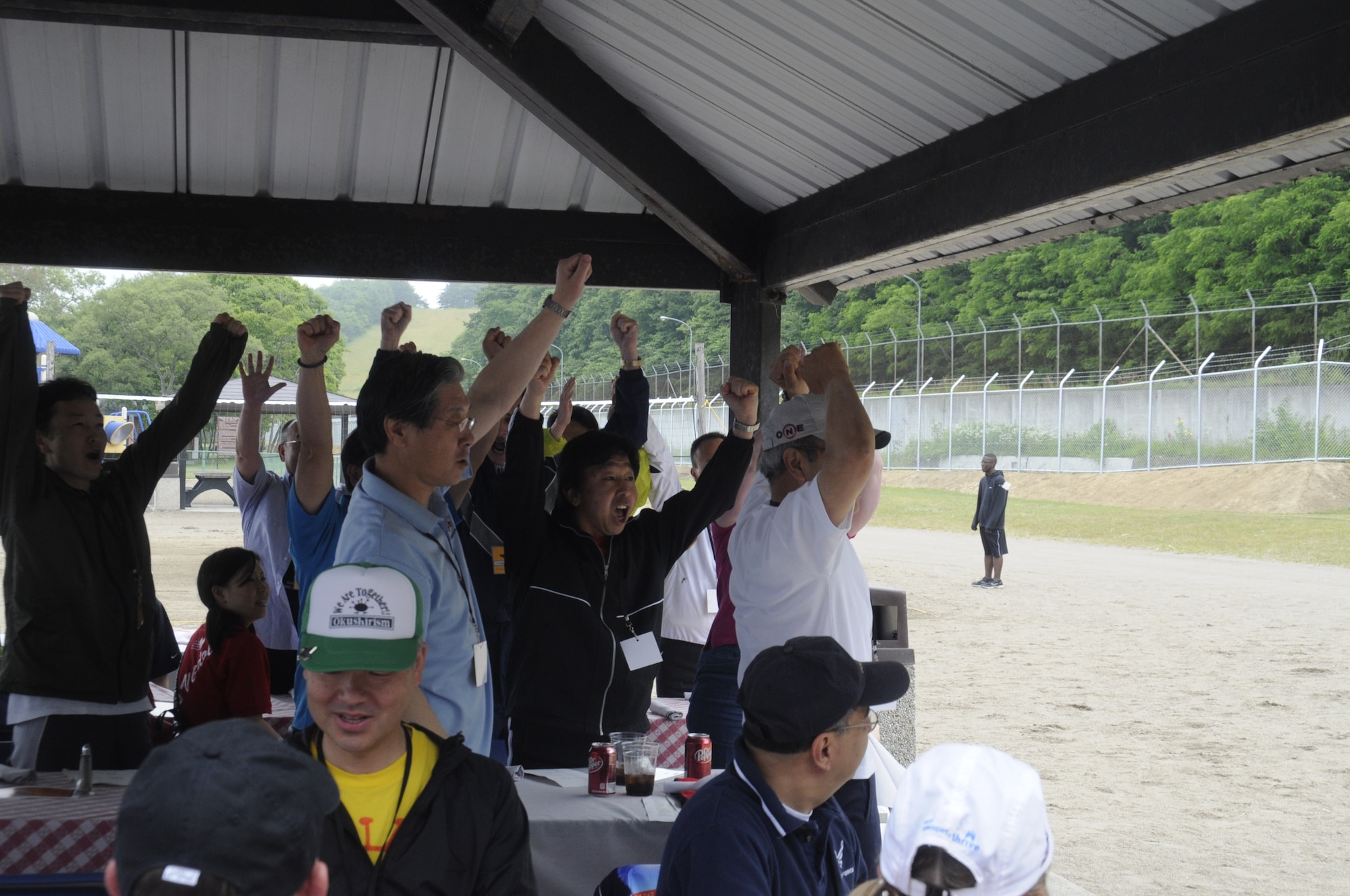 Members of Team Sabre get excited and ready for Sports Day at the base beach at Misawa Air Base, Japan, June 30, 2012. Each team stood as the master of ceremony announced their team name and cheered to get ready for the day’s events. (U.S. Air Force photo by Airman 1st Class Zachary Kee/Released)