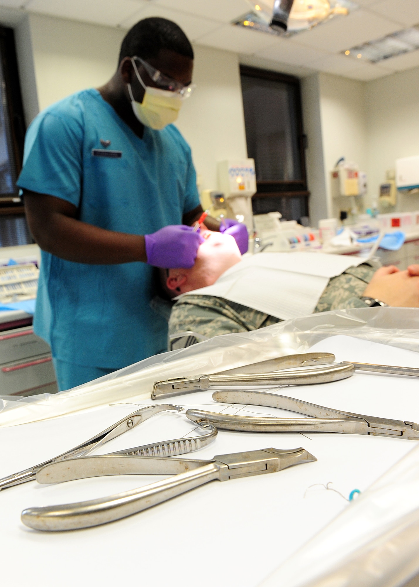 Airman 1st Class Kevin Cleveland, 86th Dental Squadron, dental assistant, adjusts a patient’s braces at the dental clinic on Ramstein Air Base, Germany, June 12, 2012.(U.S. Air Force photo/Airman 1st Class Holly Cook)