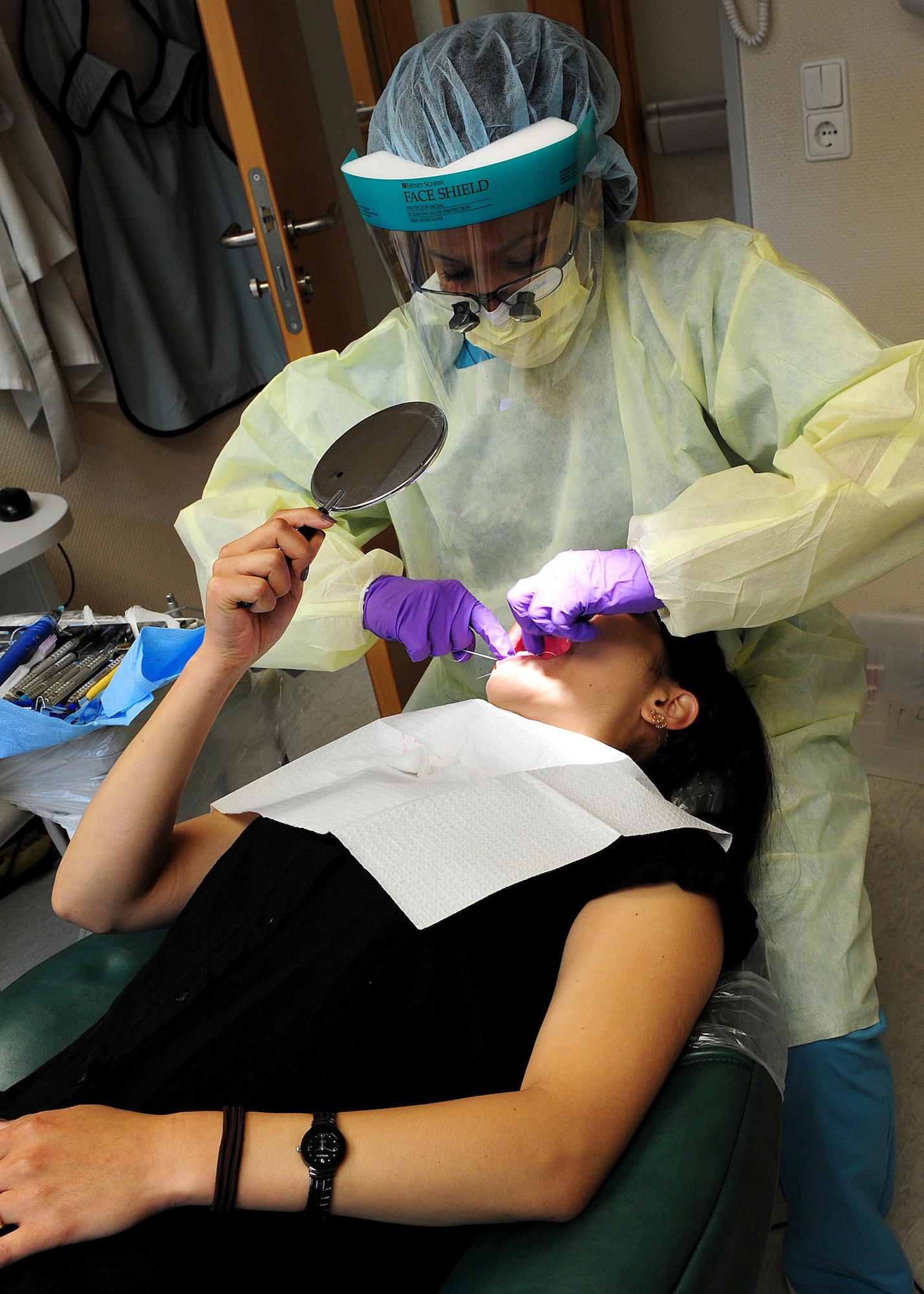 Staff Sgt. Halima Burton, 86th Dental Squadron, dental hygienist, flosses a patient’s teeth at the Dental Clinic on Ramstein Air Base, Germany, June 12, 2012.  (U.S. Air Force photo/Airman 1st Class Holly Cook)