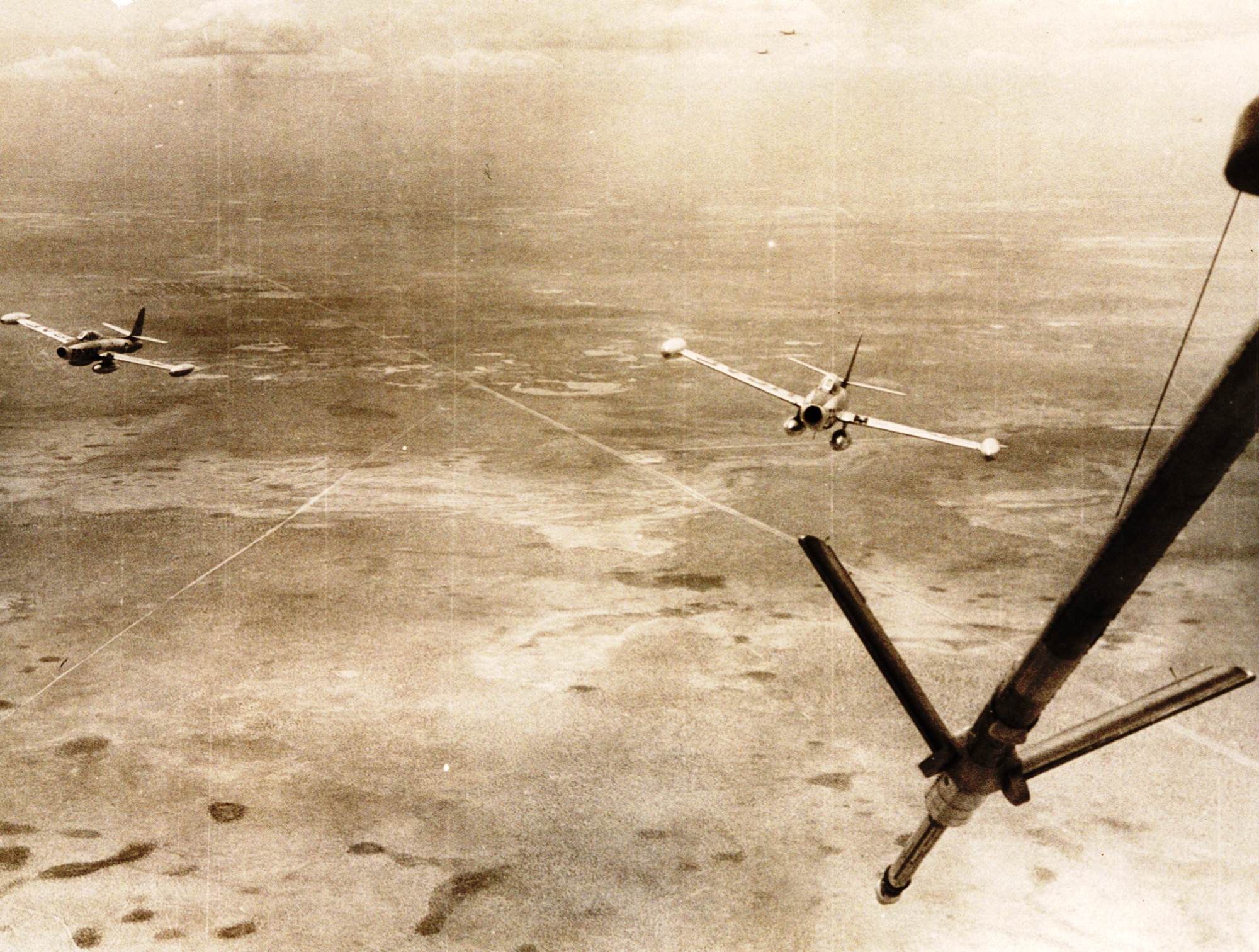 High over West Texas, two F-84Gs assigned to the 31st Fighter Escort Wing pull in behind a waiting KB-29P during Operation Fox Peter One. This was the first operation were aircraft flew across the Pacific Ocean, as opposed to being shipped. (courtesy photo)