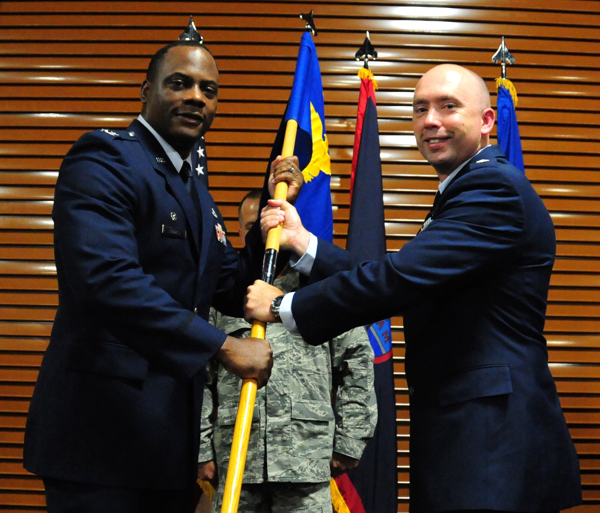 ANDERSEN AIR FORCE BASE, Guam—Col. Dwayne Thomas, 36th Mission Support Group commander, gives command of the 36th Civil Engineer Squadron to Lt. Col. Christopher Carter, incoming 36 CES commander, during a change of command ceremony June 30. Colonel Carter receives command of the 36 CES as the previous commander, Lt. Col. Michael Staples, changes duty stations. (U.S. Air Force photo by Senior Airman Benjamin Wiseman/Released)