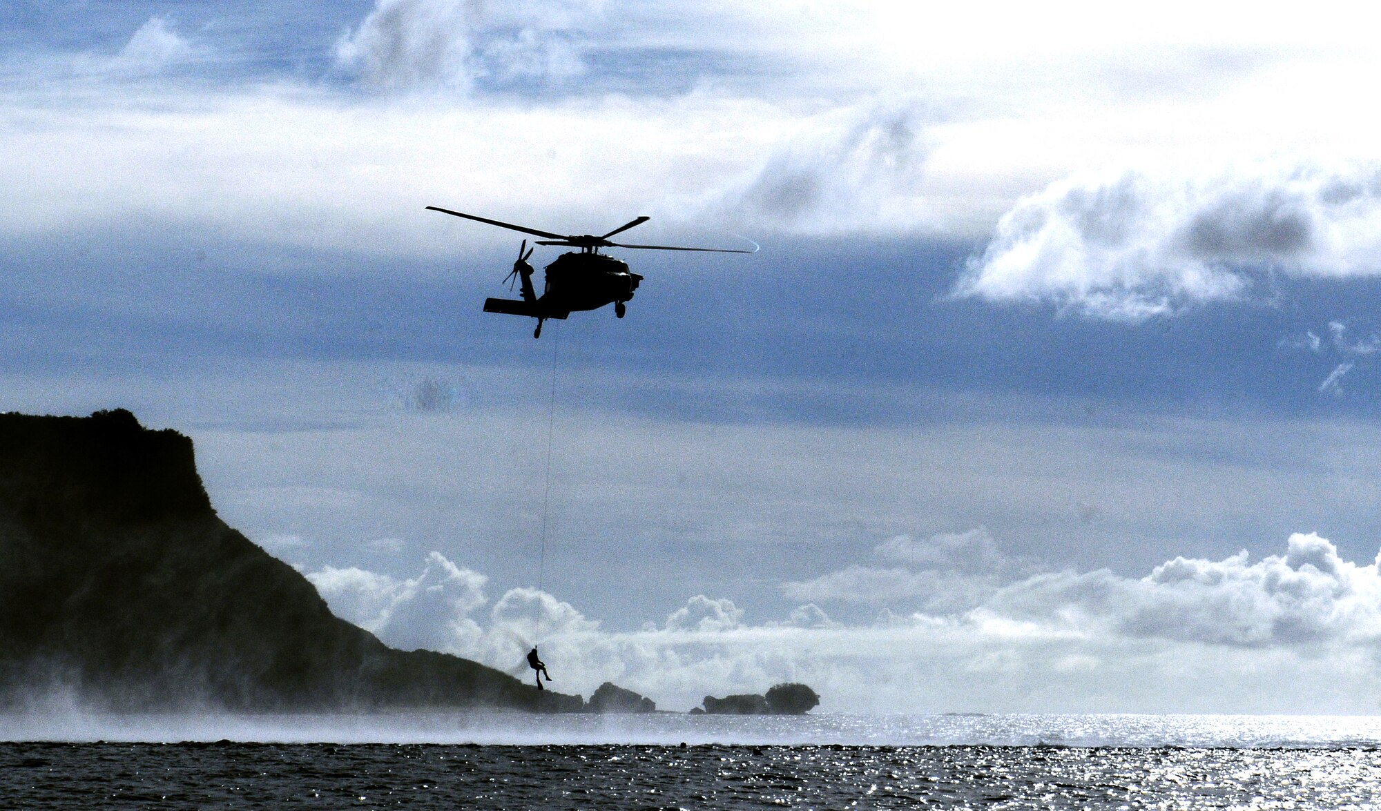 Servicemembers of Helicopter Sea Combat Squadron Two Five practice search and rescue procedures at Apra Harbor, Guam, June 14. HSC-25 servicemembers exercise their skills, keeping themselves sharp and mission-ready. U.S. Air Force photo/Airman 1st Class Mariah Haddenham/Released)