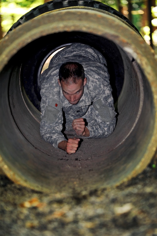 Army Staff Sgt. Jarod Moss crawls through the tunnel obstacle on a confidence course during the annual Drill Sergeant of the Year competition on Fort Eustis, Va., June 27, 2012. Moss is assigned to the 95th Reserve Division.