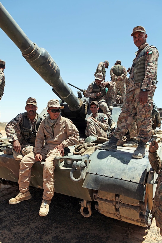 Lance Cpl. Mario Sanchez, an M1A1 Abrams tank crewman with Tank Platoon, Weapons Company, Battalion Landing Team 1st Battalion, 2nd Marine Regiment, 24th Marine Expeditionary Unit, sits on an Abrams tank with members of the Royal Jordanian Army here, May 7, 2012, during bilateral tank training as part of Exercise Eager Lion 12. More than 1,000 Marines and sailors from the 24th MEU are scheduled to participate in various events throughout Jordan to maximize multilateral training opportunities and continue to build relationships with partners throughout the region. Eager Lion 12 is the second major exercise for the 24th MEU and Iwo Jima Amphibious Ready Group after deploying in March to serve as a forward-deployed crisis-response force.