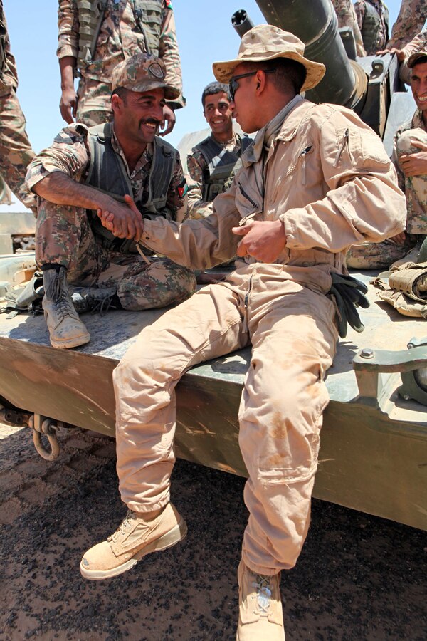 Lance Cpl. Mario Sanchez, an M1A1 Abrams tank crewman with Tank Platoon, Weapons Company, Battalion Landing Team 1st Battalion, 2nd Marine Regiment, 24th Marine Expeditionary Unit, sits on an Abrams tank with members of the Royal Jordanian Army here, May 7, 2012, during bilateral tank training as part of Exercise Eager Lion 12. More than 1,000 Marines and sailors from the 24th MEU are scheduled to participate in various events throughout Jordan to maximize multilateral training opportunities and continue to build relationships with partners throughout the region. Eager Lion 12 is the second major exercise for the 24th MEU and Iwo Jima Amphibious Ready Group after deploying in March to serve as a forward-deployed crisis response force.