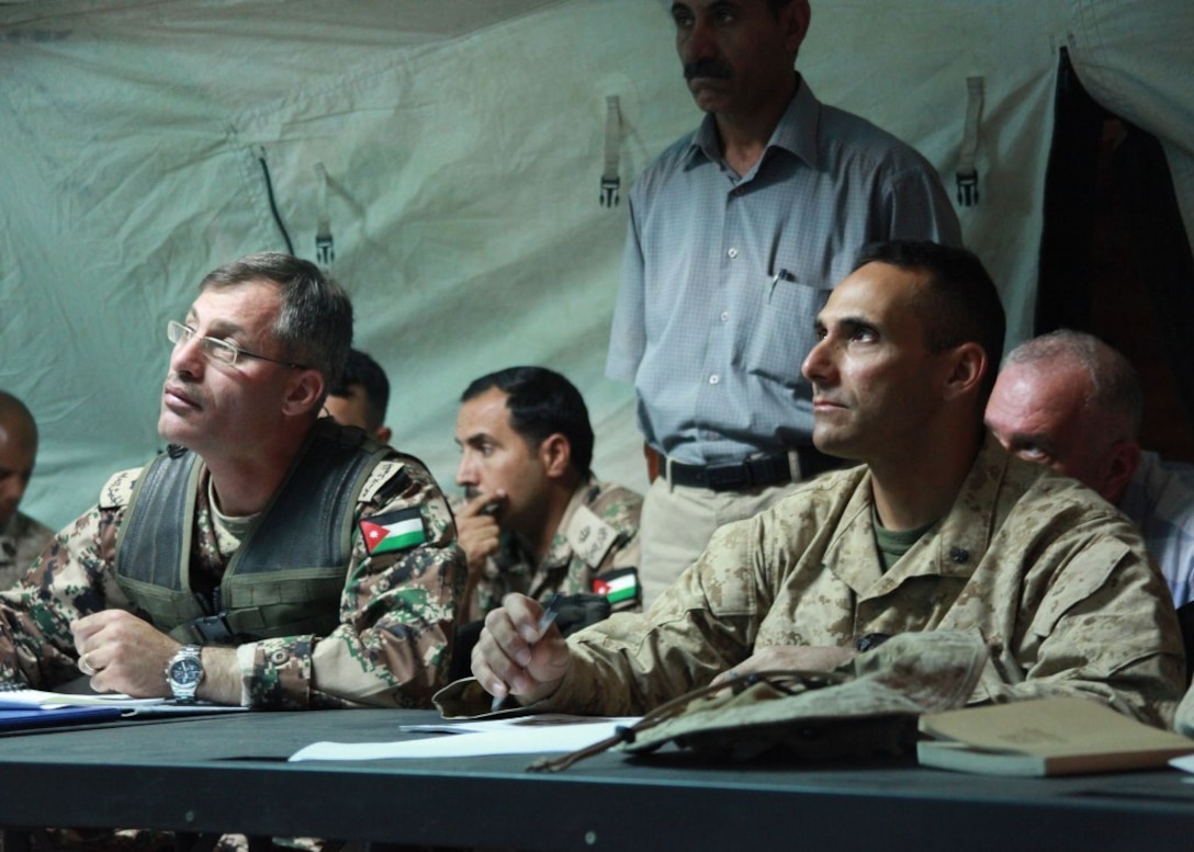 Lt. Col. David Sosa, right, commanding officer of Battalion Landing Team 1st Battalion, 2nd Marine Regiment, 24th Marine Expeditionary Unit, and Jordanian Army Lt. Col. Saif F. Alfanek, commanding officer of Jordan's 40th Mechanized Brigade, listen to an operations brief covering Exercise Eager Lion 12 here, May 8, 2012. Eager Lion is a multinational exercise designed to strengthen military-to-military relationships among partnered nations through scenario-based, realistic modern-day security challenges. The 24th MEU, partnered with the Iwo Jima Amphibious Ready Group, is currently deployed to the U.S. Central Command area of operations as a theater-reserve and crisis-response force.