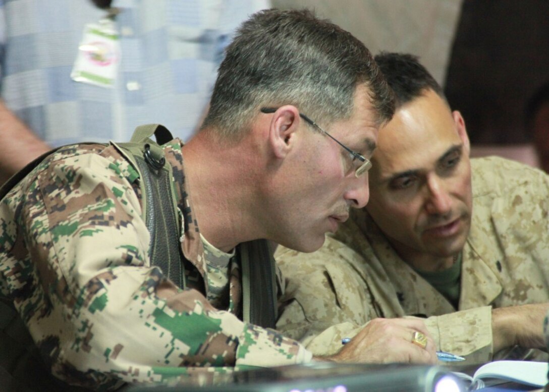 Lt. Col. David Sosa, right, commanding officer of Battalion Landing Team 1st Battalion, 2nd Marine Regiment, 24th Marine Expeditionary Unit, and Jordanian Army Lt. Col. Saif F. Alfanek, commanding officer of Jordan's 40th Mechanized Brigade, discuss the details of an operations brief covering Exercise Eager Lion 12 here, May 8, 2012. Eager Lion is a multinational exercise designed to strengthen military-to-military relationships among partnered nations through scenario-based, realistic modern-day security challenges. The 24th MEU, partnered with the Iwo Jima Amphibious Ready Group, is currently deployed to the U.S. Central Command area of operations as a theater-reserve and crisis-response force.