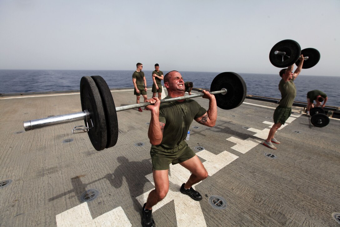 Staff Sgt. Jeffrey Perry, a Middlesex, N.J., native and the motor transportation chief with Motor Transportation Platoon, Combat Logistics Battalion 24, 24th Marine Expeditionary Unit, lifts weights during a CrossFit workout on the flight deck of the USS Gunston Hall, June 14, 2012. The 24th MEU, along with the Iwo Jima Amphibious Ready Group, is currently deployed to the U.S Central Command area of operations as a theater reserve and crisis response force. The group is providing support for maritime security operations and theater security cooperation efforts in the U.S. Navy's 5th Fleet area of responsibility.