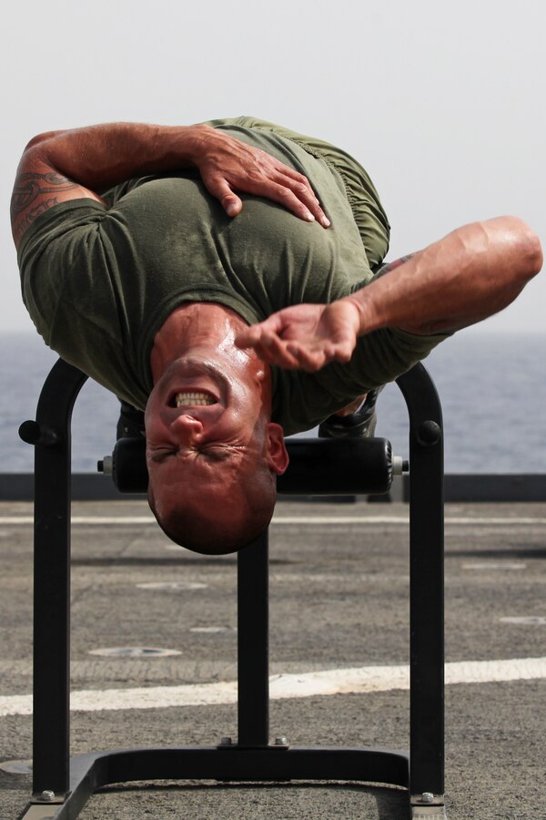 Staff Sgt. Jeffrey Perry, a Middlesex, N.J., native and the motor transportation chief with Motor Transportation Platoon, Combat Logistics Battalion 24, 24th Marine Expeditionary Unit, does sit-ups during a CrossFit workout on the flight deck of the USS Gunston Hall, June 14, 2012. The 24th MEU, along with the Iwo Jima Amphibious Ready Group, is currently deployed to the U.S Central Command area of operations as a theater reserve and crisis response force. The group is providing support for maritime security operations and theater security cooperation efforts in the U.S. Navy's 5th Fleet area of responsibility.
