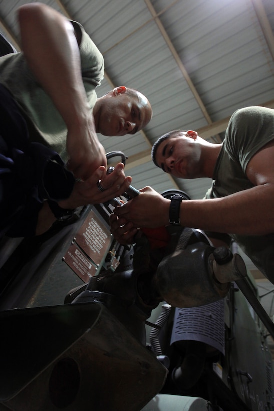 Sgt. Christopher Schneider, left, an artillery mechanic and section leader with Combat Logistics Battalion 24, 24th Marine Expeditionary Unit, and Lance Cpl. Alejandro Torrez, an artillery mechanic with India Battery, Battalion Landing Team 1st Battalion, 2nd Marine Regiment, 24th MEU, work together to fix a part for a 120 mm towed mortar system while ashore, June 24, 2012. The 24th MEU, along with the Iwo Jima Amphibious Ready Group, is currently deployed to the U.S. Central Command area of operations as a theater reserve and crisis response force. The group is providing support for maritime security operations and theater security cooperation efforts in the U.S. Navy’s 5th Fleet area of operations.