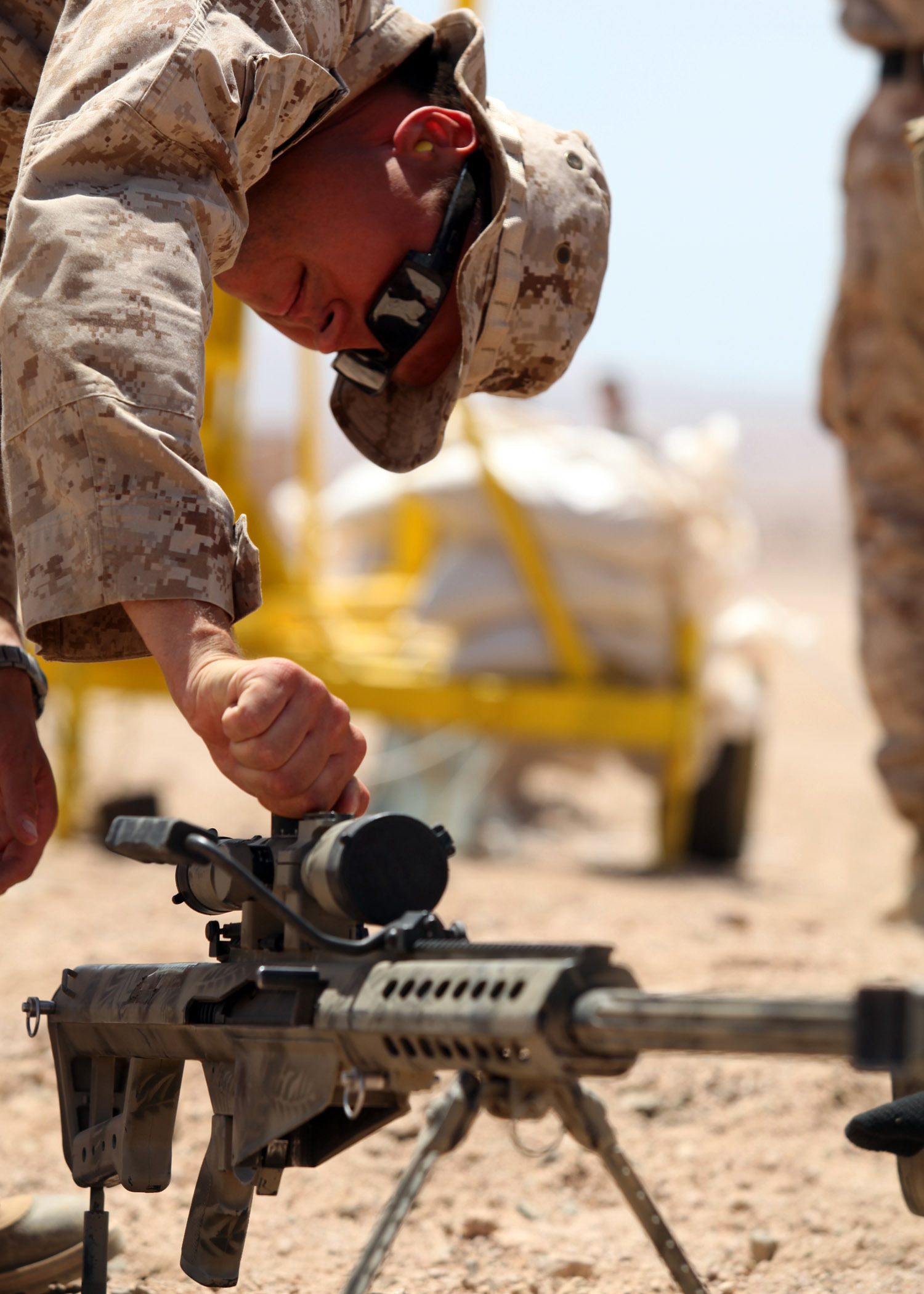 Staff Sgt. Zachary Burghart, a Maritime Raid Force team leader, 24th Marine Expeditionary Unit, changes scope settings on an M107 .50 cal Special Application Scoped Rifle, or SASR, during bilateral live-fire training with members of the Jordanian 77th Marine Reconnaissance Battalion here, May 8, 2012. The bilateral training is part of Exercise Eager Lion 12, taking place throughout the month of May and designed to strengthen military-to-military relationships of over 19 participating partner nations. This is the second major exercise for the 24th MEU who, along with the Iwo Jima Amphibious Ready Group, is currently deployed as a theater security and crisis response force.