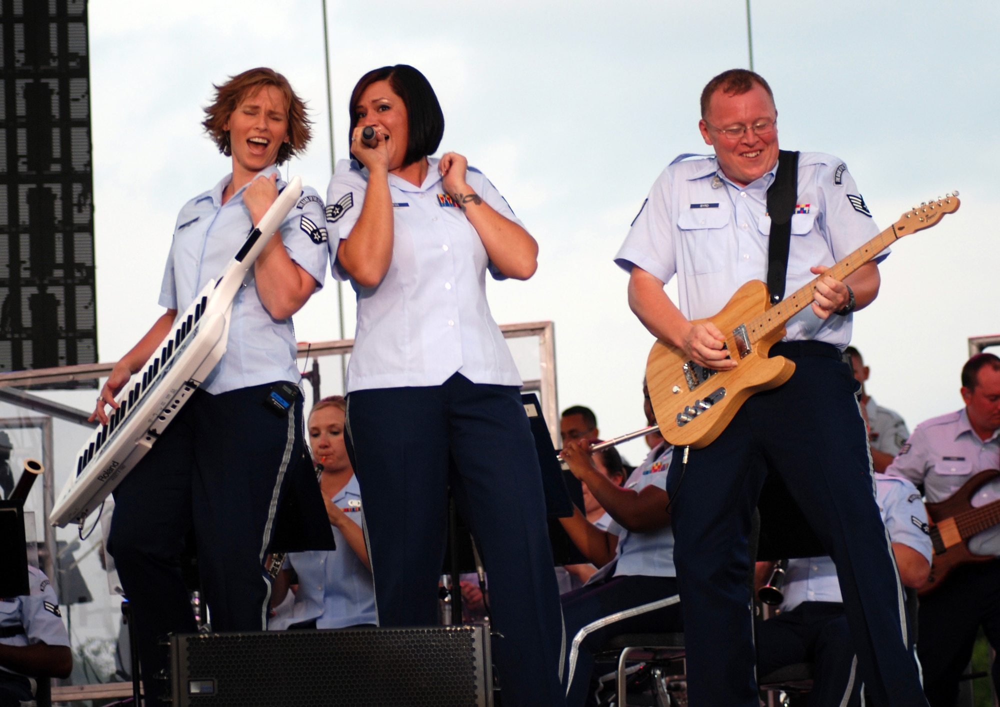 Senior Airman Michelle Hooper, Staff Sgt. Frances Kness and Staff Sgt. Josh Byrd of the Band of the U.S. Air Force Reserve perform during the annual Independence Day Celebration at McConnell Talbert Memorial Stadium in Warner Robins, Ga., July 2. (U.S. Air Force photo/Bo Joyner)