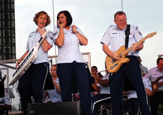 Senior Airman Michelle Hooper, Staff Sgt. Frances Kness and Staff Sgt. Josh Byrd of the Band of the U.S. Air Force Reserve perform during the annual Independence Day Celebration at McConnell Talbert Memorial Stadium in Warner Robins, Ga., July 2. (U.S. Air Force photo/Bo Joyner)