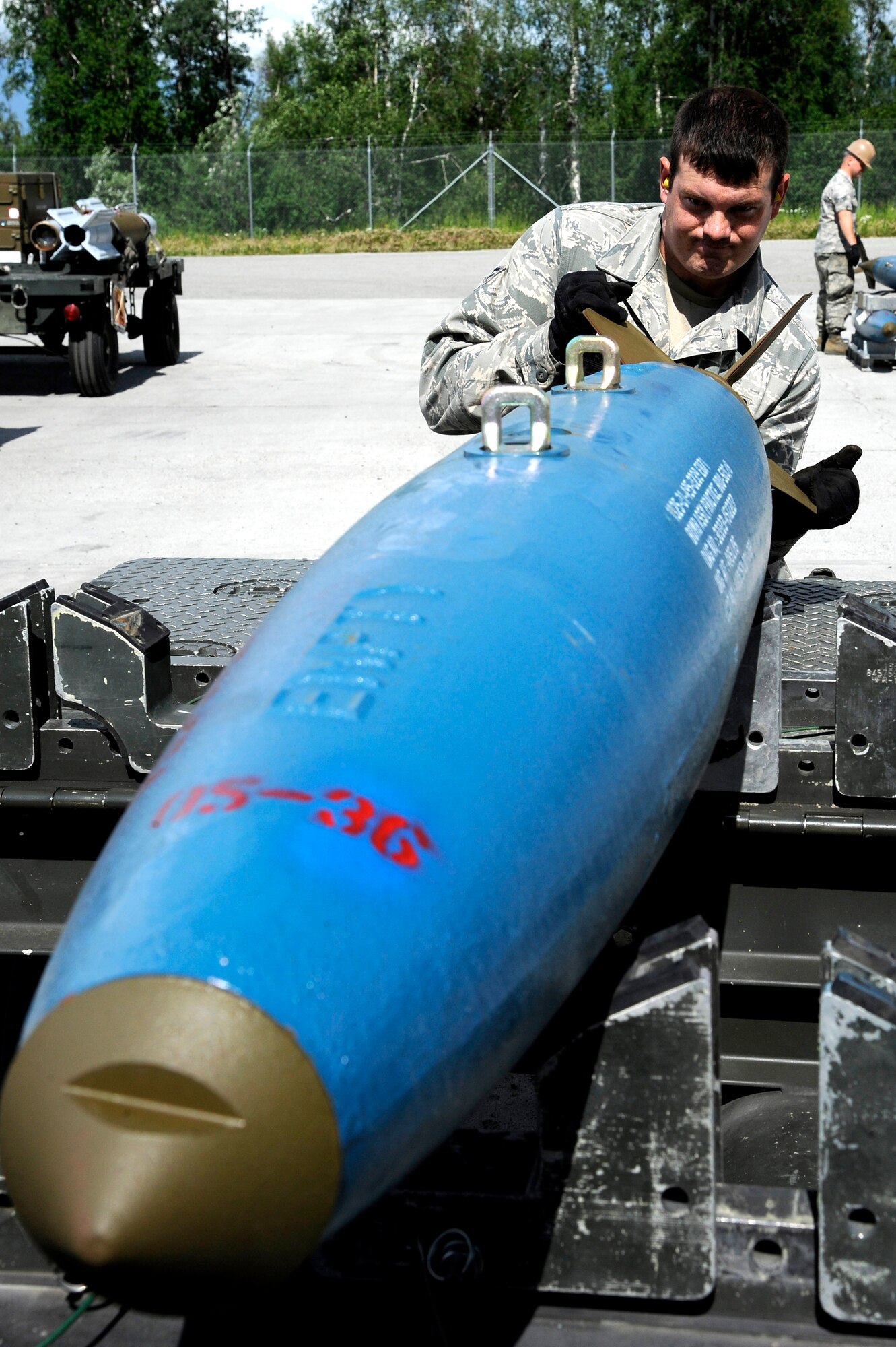 U.S. Air Force Senior Airman Thomas Johnson, 51st Munitions Squadron munitions crew chief, positions a bomb dummy unit July 2, 2012, Eielson Air Force Base, Alaska. During RED FLAG-Alaska 12-2, the munitions flight built over 2 million dollars in munitions in support of the exercise. (U.S. Air Force photo/Staff Sgt. Jim Araos)