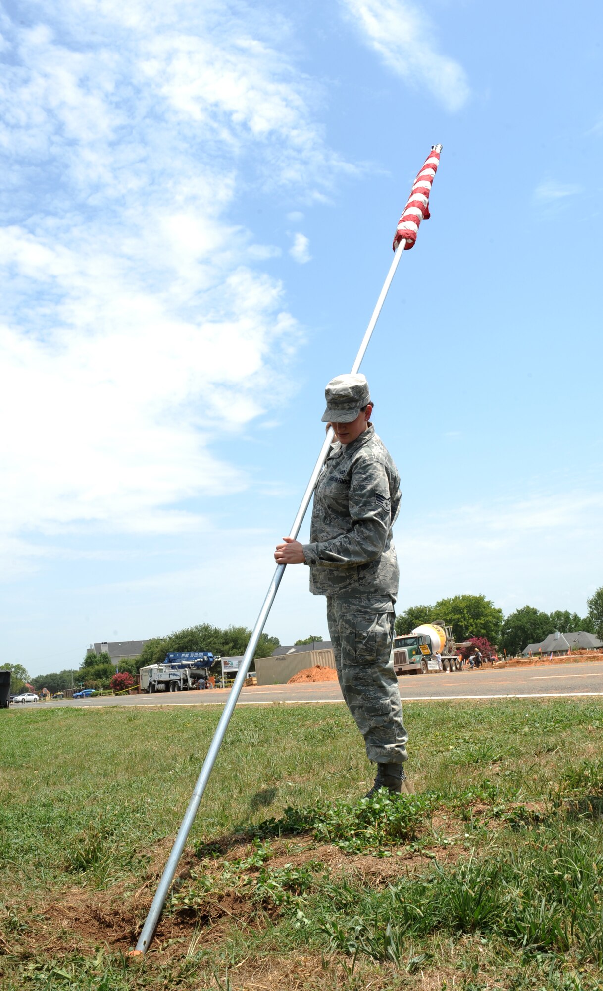 Staff Sgt. Brittany Barron, 608th Air Operations Center combat plans division, raises an American flag near the North Gate on Barksdale Air Force Base, La., July 3. Members of the 608th AOC raised more than 50 flags in celebration of Independence Day. (U.S. Air Force photo/Airman 1st Class Benjamin Gonsier)(RELEASED)
