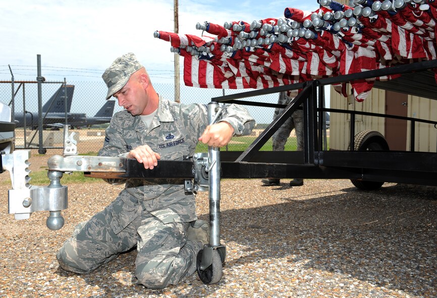 Senior Master Sgt. Robert Todd, 608th Air Operations Center, connects a trolley to the back of a vehicle on Barksdale Air Force Base, La., July 3. The trolley was used to transport more than 50 U.S. flags to the North Gate in celebration of Independence Day. (U.S. Air Force photo/Airman 1st Class Benjamin Gonsier)(RELEASED)