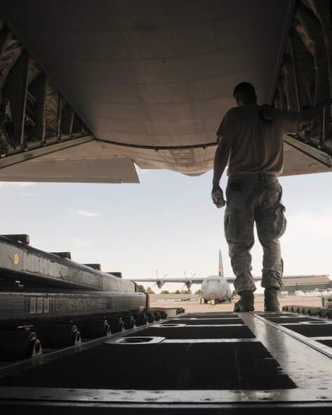 Air National Guard maintenance Airmen from the 146th Airlift Wing prepare a C-130J Super Hercules, equipped with the Modular Airborne Fire Fighting System, for aerial firefighting operations July 2 at Peterson Air Force Base, Colo. Members of the 146th AW are activated along with the ANG's 153rd AW, as well as the Air Force Reserve's 302nd AW, to assist with firefighting efforts in the Rocky Mountain Area. The 146th AW is based at Channel Islands, Calif. (U.S. Air Force photo/Senior Airman Nicholas Carzis)