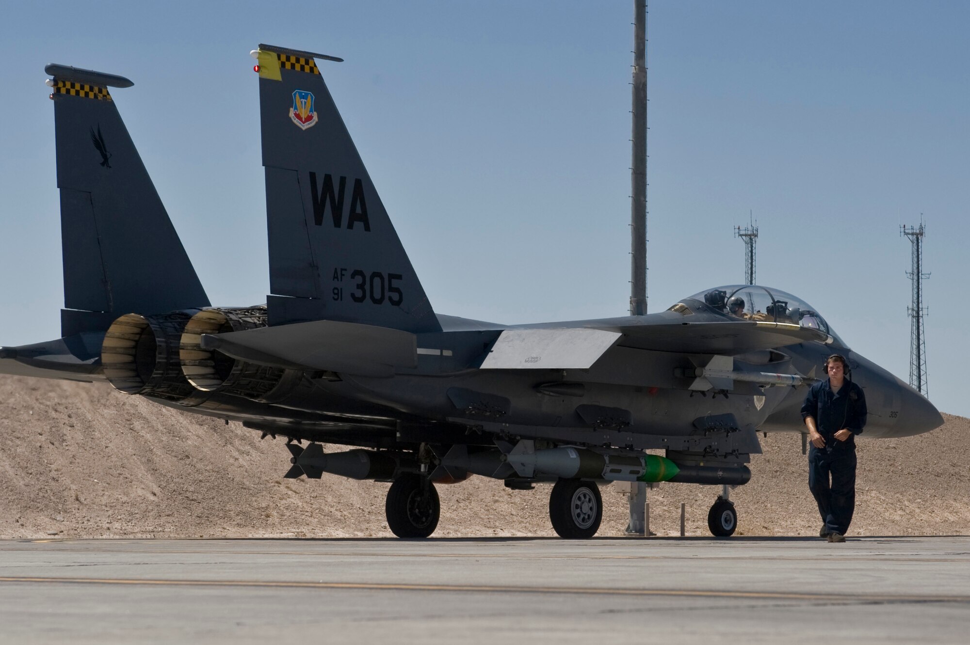 U.S. Air Force Senior Airman Noah Putman, 757th Aircraft Maintenance Squadron crew chief, walks away after marshalling an F-15 Eagle during MIDWAY WHITE III June 28, 2012 at Nellis Air Force Base, Nev. The Joint exercise is designed to provide urgently needed data to the warfighter at a fraction of the time and cost of a traditional Defense Threat Reduction Agency test or experiment series.  (U.S. Air Force photo by Airman 1st Class Daniel Hughes)
