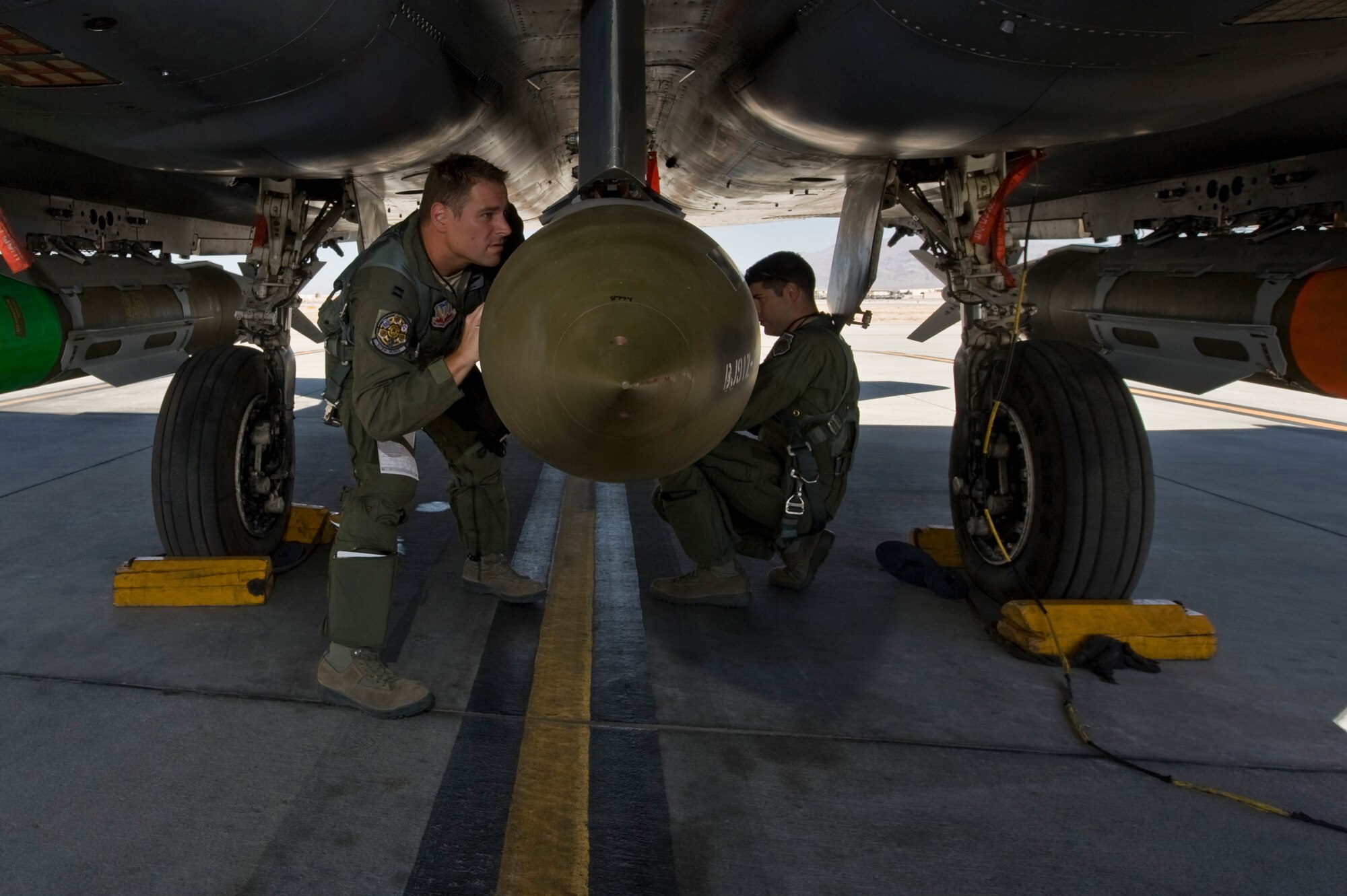 U.S. Air Force Capt. Aaron Reid, 17th Weapons Squadron pilot and Capt. Joshua Blakeman, 17th Weapons Squadron weapons systems officer, go through a pre-flight checklist before taking part in  MIDWAY WHITE III June 28, 2012, on Nellis Air Force Base, Nev. MIDWAY WHITE III demonstrates the weapon-aircraft interaction, weapon capabilities, aircraft stores management systems, and bomb release units of existing weapon systems utilized in cave attack environments. (U.S. Air Force photo by Airman 1st Class Daniel Hughes)
