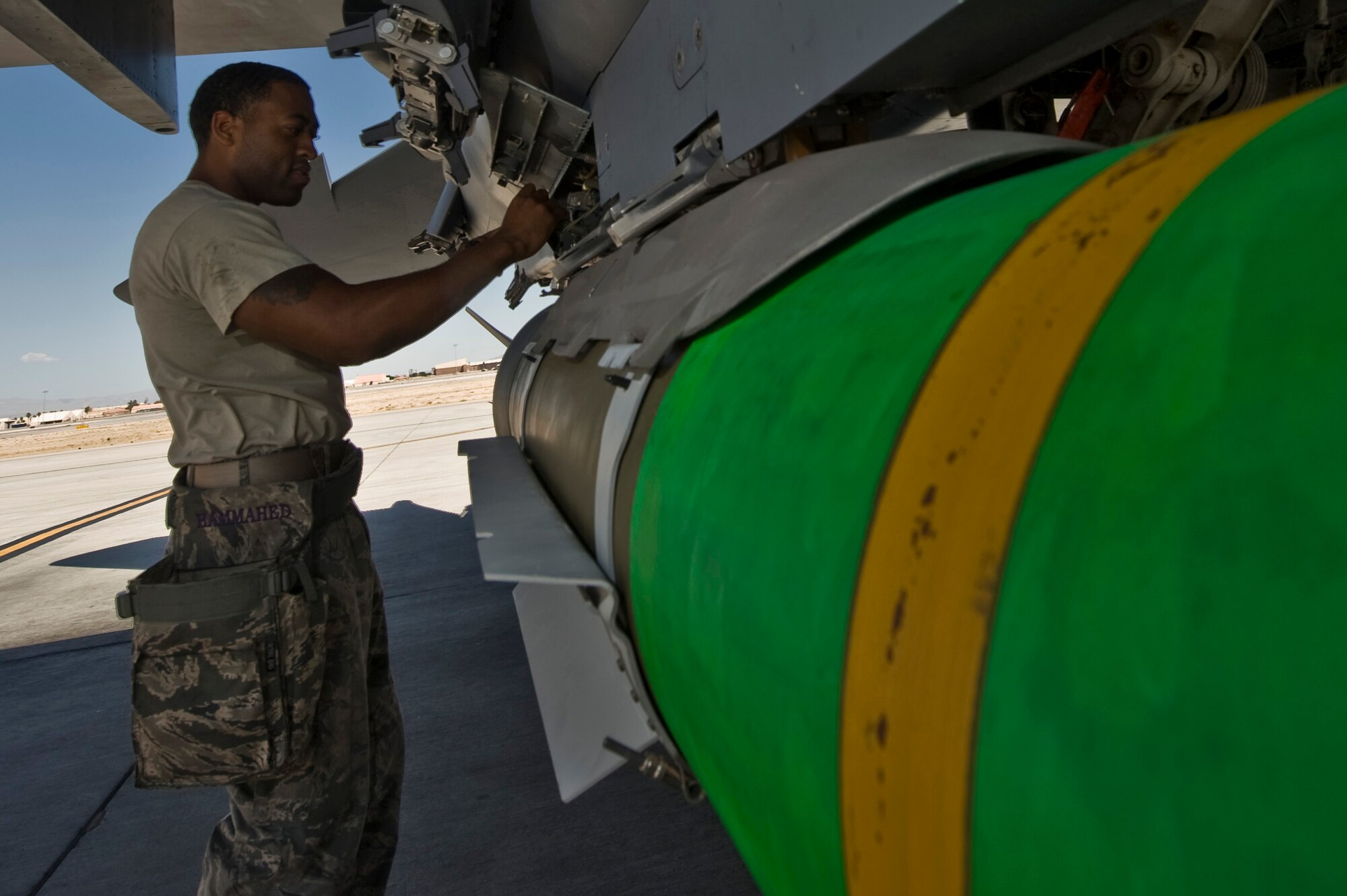 U.S. Air Force Staff Sgt. Julius Anglin, 757th Aircraft Maintenance Squadron munitions systems craftsman, performs pre-flight checks on a live guided bomb unit version 4 during MIDWAY WHITE III June 28, 2012 at Nellis Air Force Base, Nev. MIDWAY WHITE III is designed to standardize cave characterization methods and universal cave weaponeering procedures that consistently result in the successful prosecution of enemy forces operating from cave environments.  (U.S. Air Force photo by Airman 1st Class Daniel Hughes)
