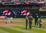 Women from all services were honored on July 1, 2012 at Target Field in Minneapolis as the Minnesota Twins held military appreciation day for members and their families. A formation of about thirty women in uniform took up part of the outfield as a large flag held by members of the Minnesota National Guard filled up more. The singers for the Star Spangled Banner were 2nd Lt. Darcy Reller and Airman 1st Class Jessica Reller of the 133rd Airlift Wing. Children of military members participated by standing by players during the announcement of the lineup. USAF official photo