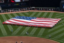 Women from all services were honored Sunday, July 1, 2012 at Target Field in Minneapolis as the Minnesota Twins held military appreciation day. A formation of about thirty women in uniform took up part of the outfield as a large flag held by members of the Minnesota National Guard filled up more. The singers for the Star Spangled Banner were 2nd Lt. Darcy Reller and Airman 1st Class Jessica Reller of the 133rd Airlift Wing. Many others, including veterans and family members of the military, took part in activities all day long and received free tickets to see the game. USAF official photo by Staff Sgt. Austen Adriaens