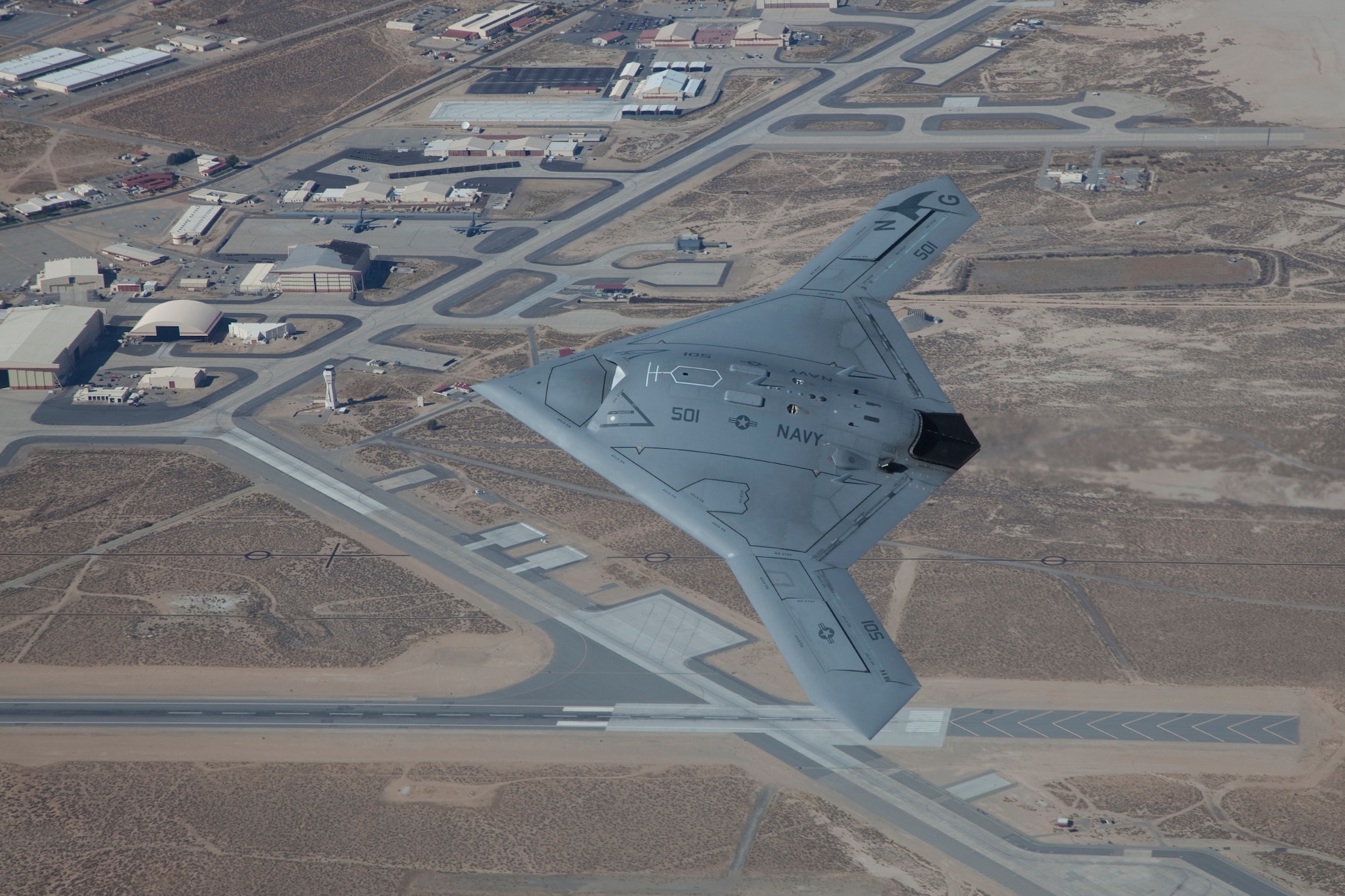 The U.S. Navy's X-47B Unmanned Combat Air System demonstrator flies over Edwards during a routine test mission. The UCAS-D program conducted the airworthiness test phase for the X-47B at Edwards, which came to a successful conclusion May 15 after more than two years of testing. Team Edwards will continue to support the program, as the 412th Maintenance Group will send personnel to Naval Air Station Patuxent River, Md., to continue supporting in the aircraft carrier suitability test phase. (U.S. Air Force Photo by Chris Neill)