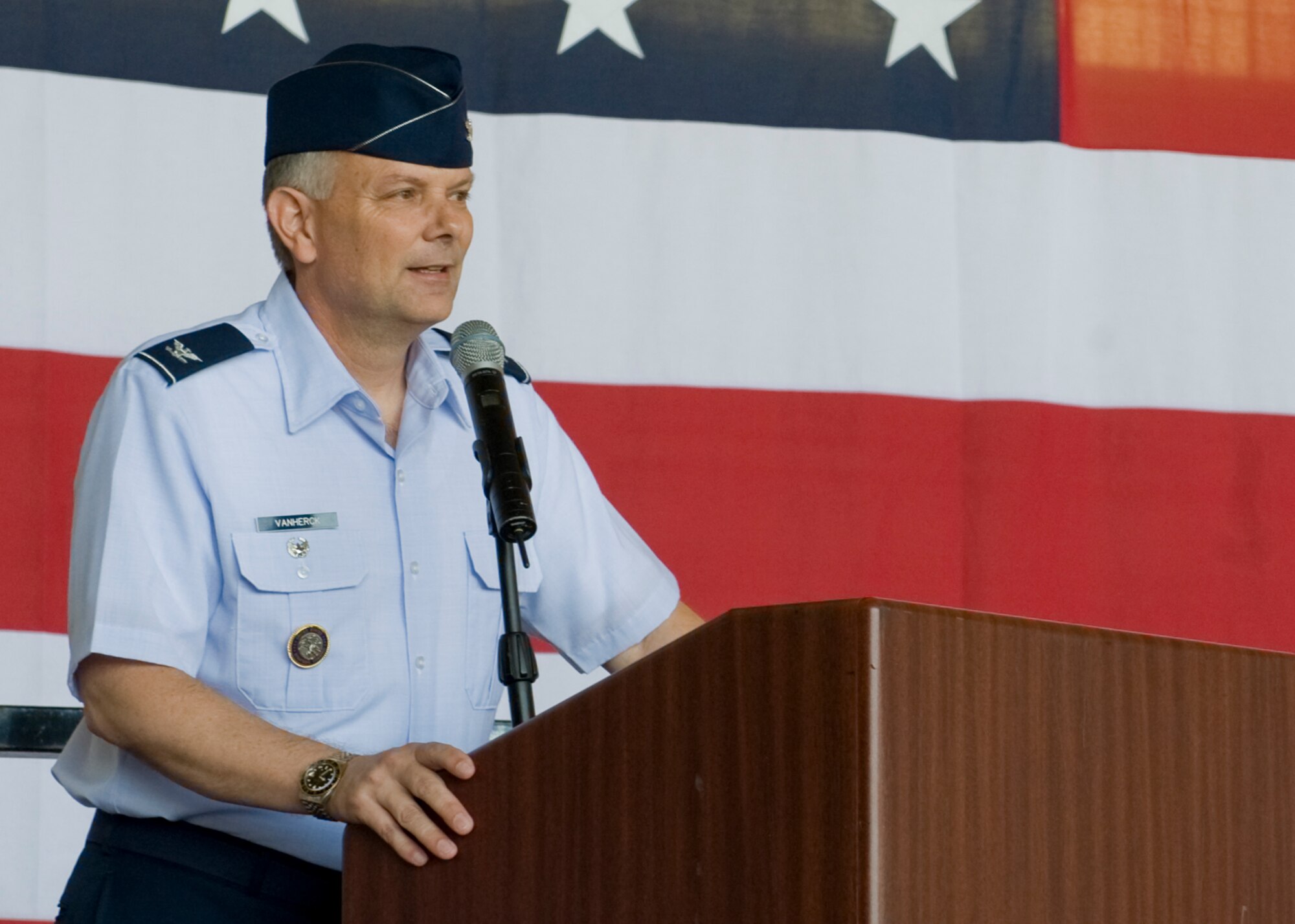 Col. Glen VanHerck, 7th Bomb Wing commander, addresses Team Dyess during the 7th Bomb Wing change of command ceremony July 3, 2012, at Dyess Air Force Base, Texas. VanHerck assumed command of the 7th Bomb Wing from Col. David Béen during a ceremony held in the three-bay hangar. As commander, VanHerck is responsible for the health and welfare of more than 12,000 active duty military members, civilian employees and family members. In addition, he provides combat-ready B-1 aircraft, crews and associated combat support of global engagement taskings. (U.S. Air Force photo by Airmen 1st Class Peter Thompson/ Released)