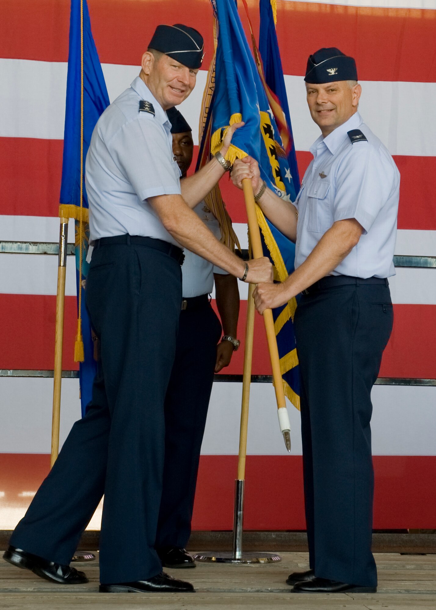 U.S. Air Force Lt. Gen. Robin Rand, left, 12th Air Force commander, hands the guide-on to Col. Glen VanHerck, 7th Bomb Wing commander, during the 7th Bomb Wing change of command ceremony July 3, 2012, at Dyess Air Force Base, Texas. VanHerck assumed command of the 7th Bomb Wing from Col. David Béen during a ceremony held in the three-bay hangar. As commander, VanHerck is responsible for the health and welfare of more than 12,000 active duty military members, civilian employees and family members. In addition, he provides combat-ready B-1 aircraft, crews and associated combat support of global engagement taskings. (U.S. Air Force photo by Airmen 1st Class Peter Thompson/ Released)