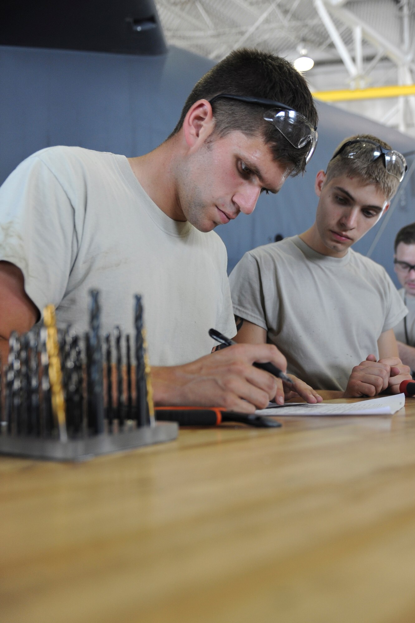 Airman 1st Class Michael Romanyak (left) and Senior Airman Joshua Martinez, 2nd Maintenance Squadron, check an Air Force Form 380 after completing a job in the Phase Hangar on Barksdale Air Force Base, La., July 2. The form is used to locate and track the work each aircraft needs. After a weekend of riding his dirt bike, Romanyak came back to work refreshed and ready to support the mission. (U.S. Air Force photo/Airman 1st Class Micaiah Anthony)(RELEASED)
