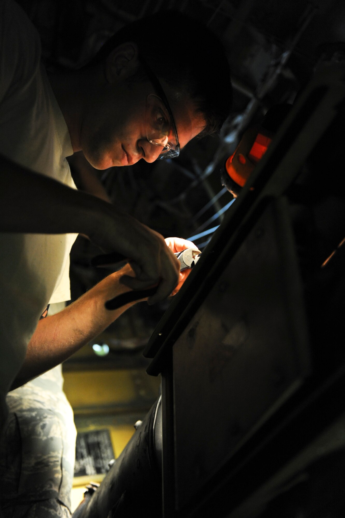 Airman 1st Class Michael Romanyak, 2nd Maintenance Squadron, cuts a rivet in the tail section of a B-52H Stratofortress on Barksdale Air Force Base, La., July 2. Romanyak enjoys riding dirt bikes and competing in local Motocross competitions in his spare time. According to Romanyak, the activity helps him come back to work refreshed and ready to support the mission. (U.S. Air Force photo/Airman 1st Class Micaiah Anthony)(RELEASED)
