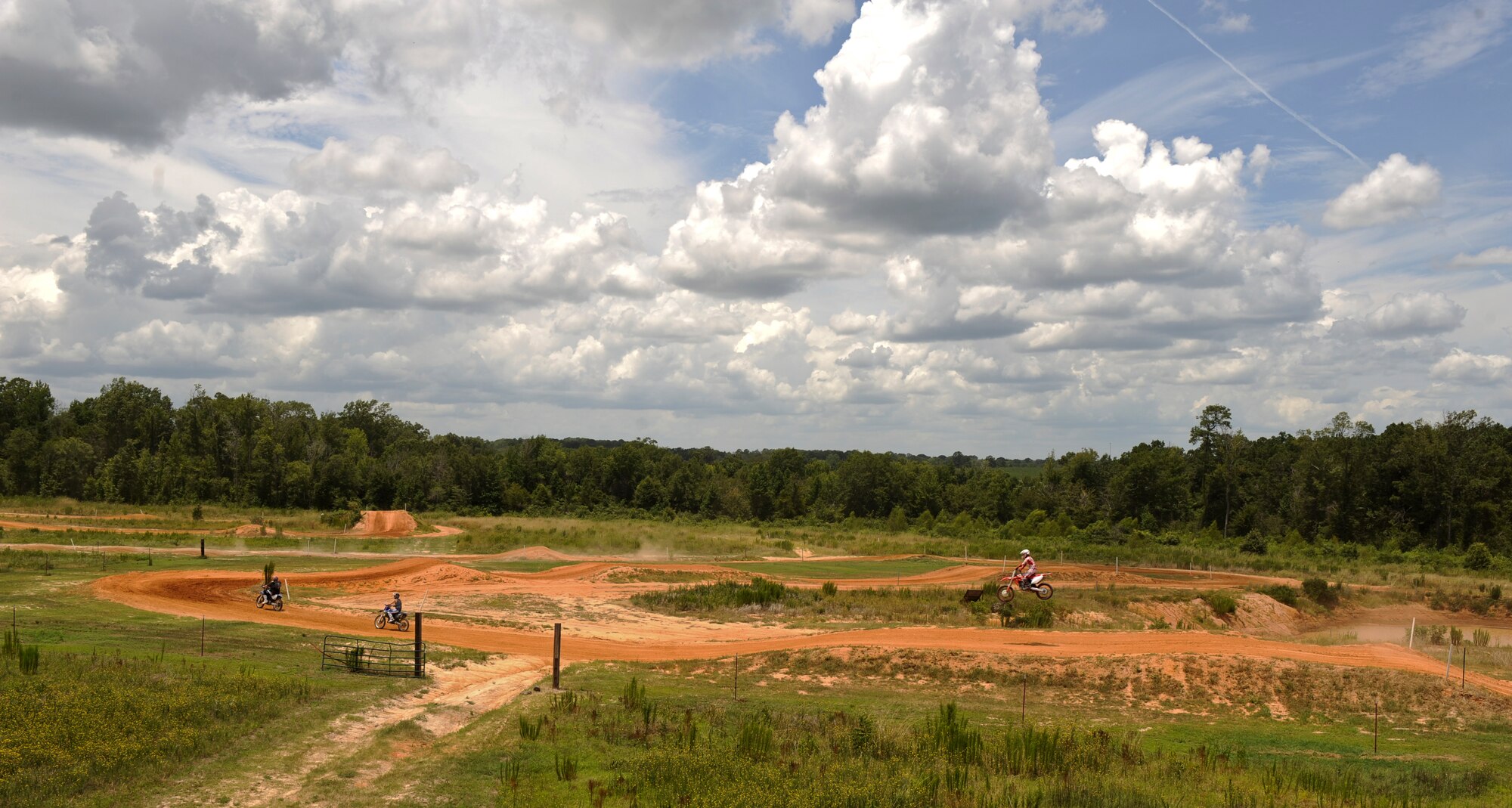 Local dirt bike enthusiasts ride around a dirt track in Mansfield, La., July 1. Every weekend a few Barksdale Air Force Base Airmen visit Motocross tracks in the local area to practice and hone their riding techniques. In order to ride and race dirt bikes, Airmen must complete the motorcycle safety course at Barksdale Air Force Base along with having a high-risk activity briefing from their commander. (U.S. Air Force photo/Airman 1st Class Micaiah Anthony)(RELEASED)
